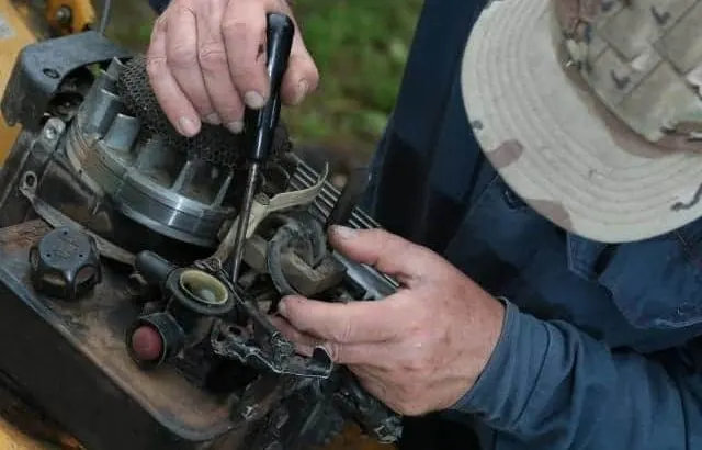 Fix a lawn mower that is burning oil.