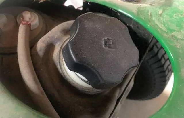 Why is my lawnmower spitting gas from the fuel cap?
